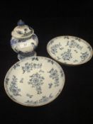 A pair of 19th Century Delft blue and white shallow bowls decorated with floral sprays,