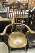 A 19th Century elm stick back elbow chair,