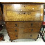 A 20th Century oak bureau of three drawers, a small oak gate-leg coffee table,