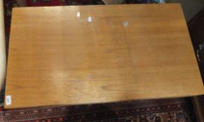 A Gordon Russell teak coffee table on two chrome supports (no label but purchased from Gordon