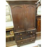 A Victorian mahogany linen press, the top with two doors opening to reveal a hanging space,