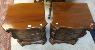 A pair of modern cherry bedside chests, the shaped tops above three drawers,