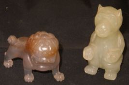 A carved Chinese agate standing lion together with a carved jade bear in seated pose