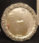 A silver salver with shell and acanthus decoration and pie-crust rim and with engraved decoration