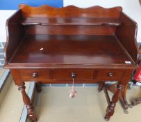 A mahogany washstand with three quarter galleried top above three short drawers,