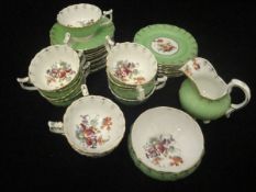 A box containing a small collection of Dresden porcelain coffee wares painted with floral sprays,