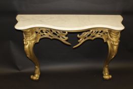 A Louis XV style console table with serpentine fronted marble top on a carved and pierced giltwood