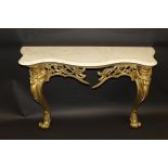 A Louis XV style console table with serpentine fronted marble top on a carved and pierced giltwood