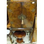 A burr walnut drinks cabinet, raised on cabriole legs,