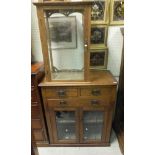 An oak shop display cabinet with three shelves and single glazed door,