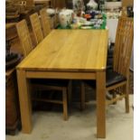 A modern oak dining table of plain form,