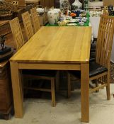 A modern oak dining table of plain form,