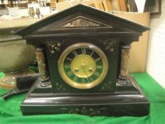 A late Victorian black slate and marble cased mantel clock of architectural form,