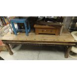 An Indian rectangular hardwood dining table with panelled top and iron bindings and supports,