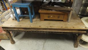 An Indian rectangular hardwood dining table with panelled top and iron bindings and supports,