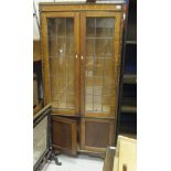 A 1920's oak and leaded glazed display cabinet with applied beaded decoration