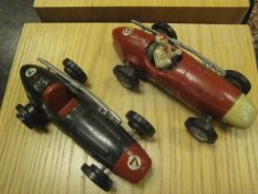 A circa 1958 Scalextric Mazerati 250F in red with cream nose cone and driver and another in green