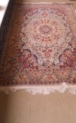 An Indian/Persian design rug, the central floral medallion in pale green, terracotta,