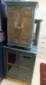 An Indian painted teak two door glazed display cabinet on square supports,