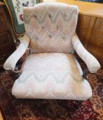 A pair of mahogany framed armchairs in the Howard manner, upholstered in peach, green and cream,