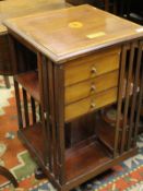 An Edwardian mahogany and crossbanded revolving library bookcase with three drawers bearing brass