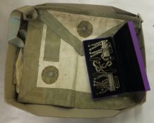 A box containing Masonic aprons and attachments,