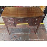 A mahogany and banded bow front kneehole dressing table with five assorted drawers with brass drop