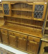 A modern pine dresser, the top with two glazed cupboards and three plate shelves above a plain top,