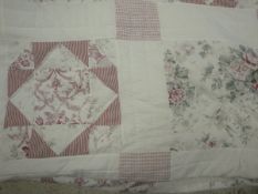 Two modern double bedspreads, one with pink and green floral decoration on white ground,