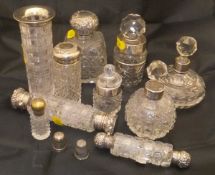 A small box containing a collection of cut glass dressing table items with silver mounts and silver