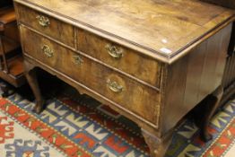 An early 18th Century walnut chest of two short and one long drawer,