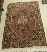 A Persian rug, the central medallion in cream, terracotta,