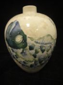 A Liza B Moorcroft pottery vase with pearlised crackle ware glaze and decorated with a fish in