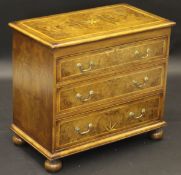 A walnut and inlaid chest of three drawers in the early 18th Century manner,