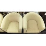 A set of three modern tub armchairs upholstered in oatmeal fabric