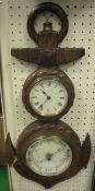 A circa 1900 carved oak framed wall clock with aneroid barometer of anchor form