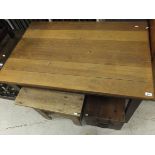 A pine and oak kitchen table with end drawer, raised on square legs,