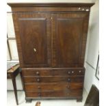 A Regency mahogany linen press, the upper section with two cupboard doors enclosing a hanging space,