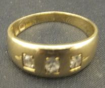 An 18 carat gold dress ring set with three small diamonds, approx 4.