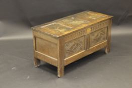 An 18th Century oak coffer, the triple panelled top above linenfold carving to front,