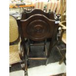 An early 20th Century mahogany framed rocking chair with canework seat and back,