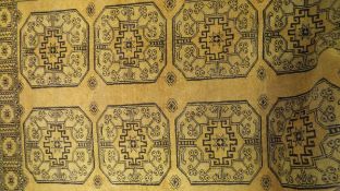 An Afghan rug, the ten central elephant foot medallions in pale gold,