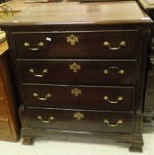 An 18th Century oak chest of drawers the plain top above four long drawers with fluted column