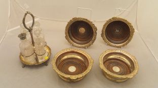 A set of four silver plated wine coasters,