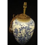 A Chinese porcelain jar decorated in under glaze blue with birds amongst branches (converted to a