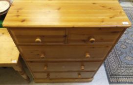 A modern pine chest of two short over three long drawers