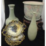 A large Chinese porcelain celadon vase raised on an associated wooden base,