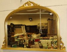 A modern over mantel mirror in the Victorian manner with arched top and gilt frame