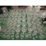 A large part suite of late 19th / early 20th Century cut glass to include a pair of large decanters,
