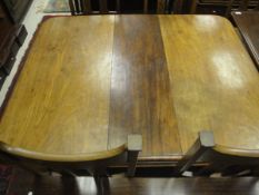 A Victorian mahogany rounded rectangular extending dining table on turned and reeded tapering legs